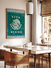 Viva Mexico Wall Art with white Mexican eagle emblem on dark green, blue patterned borders, in a styled room mockup