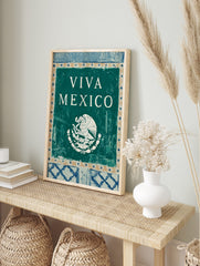 Viva Mexico wall art with white text and Mexican national emblem of eagle and snake on teal, in an alternate framed mockup