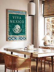 Viva Mexico wall art with white text and Mexican national emblem of eagle and snake on teal, in a styled room mockup