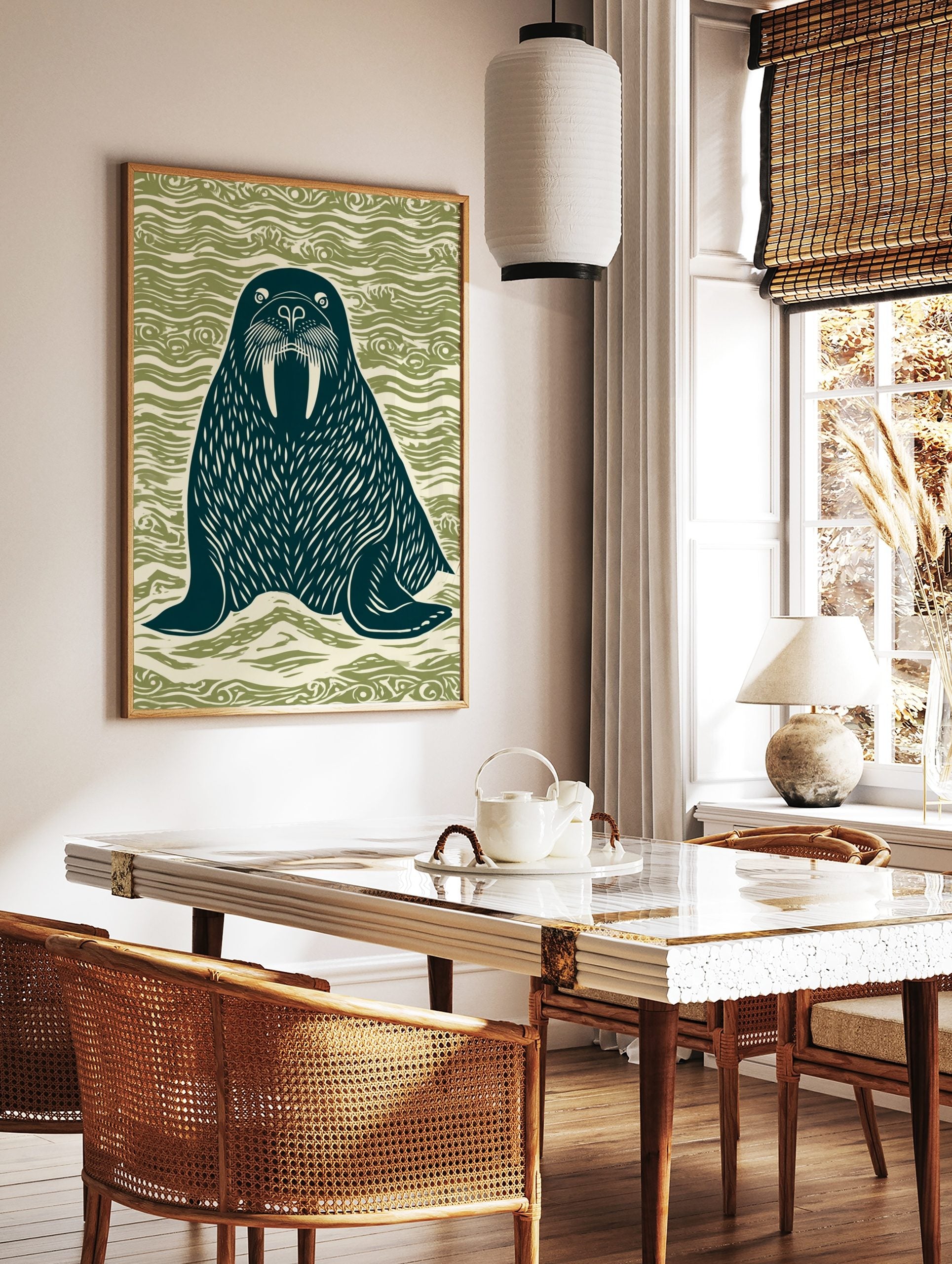 Linocut style walrus illustration with large tusks, dark teal on wavy green background, in a styled room mockup