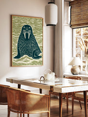 Linocut style walrus illustration with large tusks, dark teal on wavy green background, in a styled room mockup
