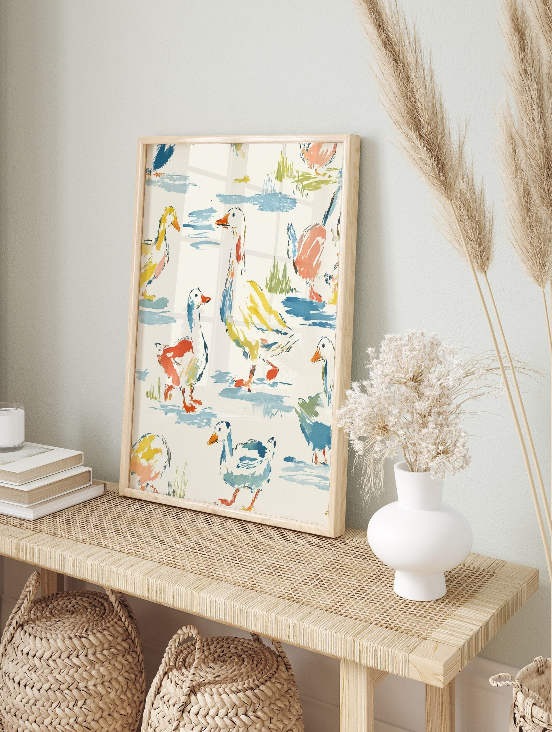 Watercolour illustration of ducks and geese in various poses on a light background with blue, in an alternate framed mockup