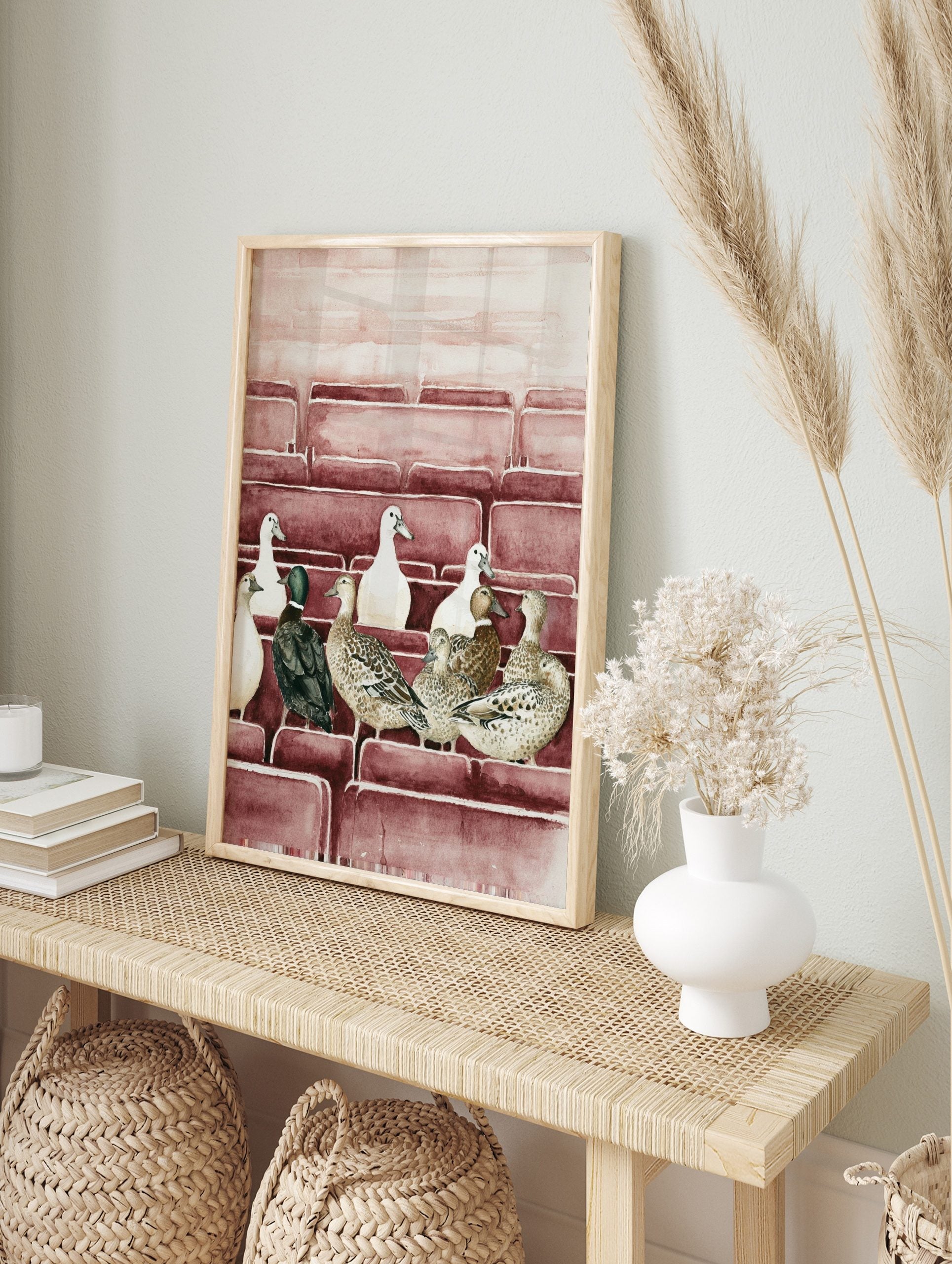 Watercolour illustration of multiple ducks (white, brown, green-headed) sitting in rows on, in an alternate framed mockup