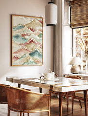 Watercolour mountain range art print with layered peaks in beige, teal, maroon, white, and gold, in a styled room mockup