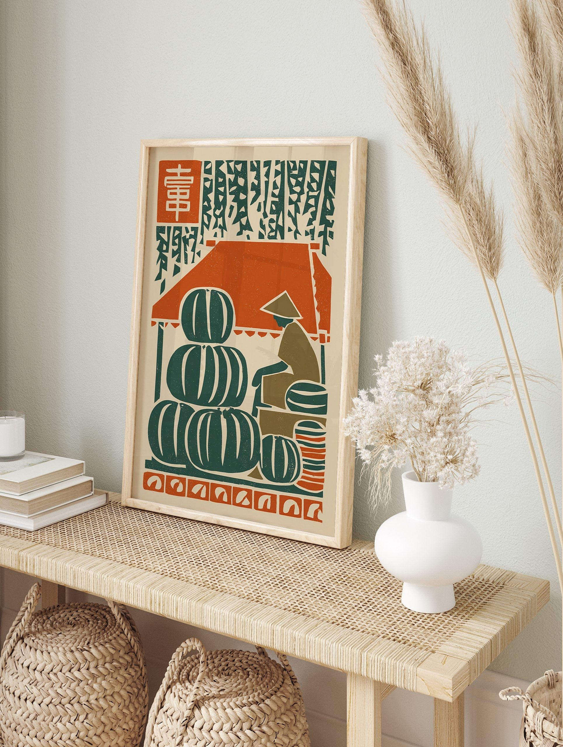 Woodcut style art print of a market with stacked green watermelons, a vendor, and red kanji, in an alternate framed mockup