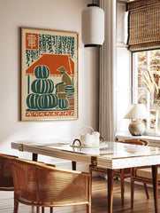 Woodcut style art print of a market with stacked green watermelons, a vendor, and red kanji, in a styled room mockup