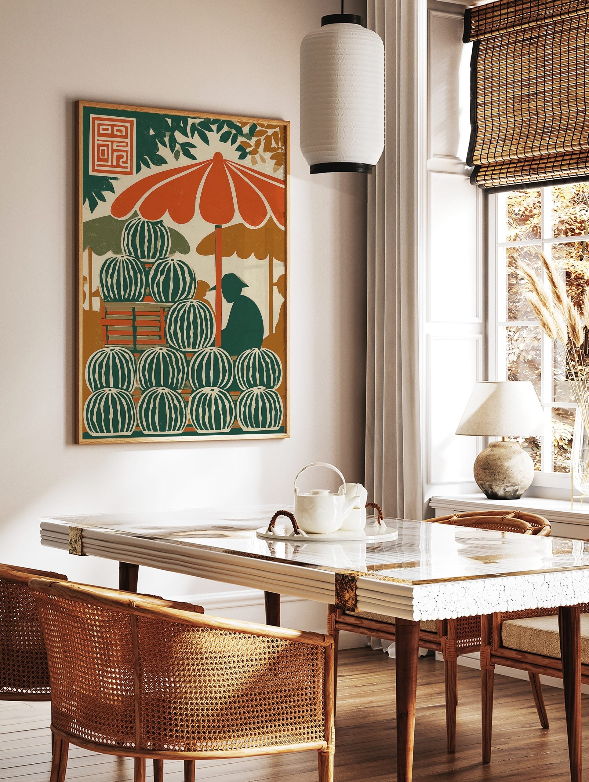 Illustrative print of a watermelon stand with stacked fruit, orange umbrella, and vendor silhouette, in a styled room mockup