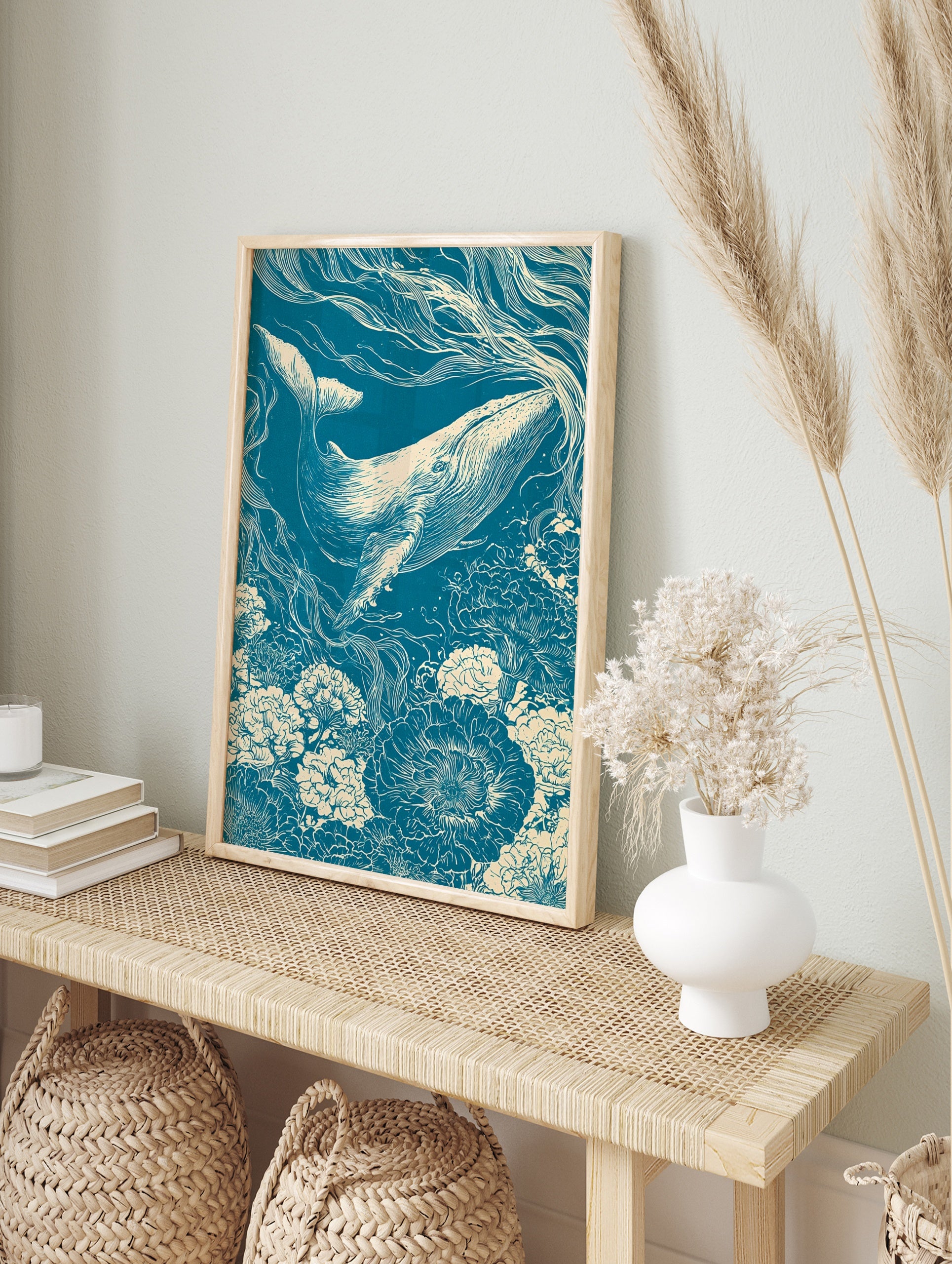 Linocut-style illustration of a whale swimming through a field of flowers in teal and cream, in an alternate framed mockup