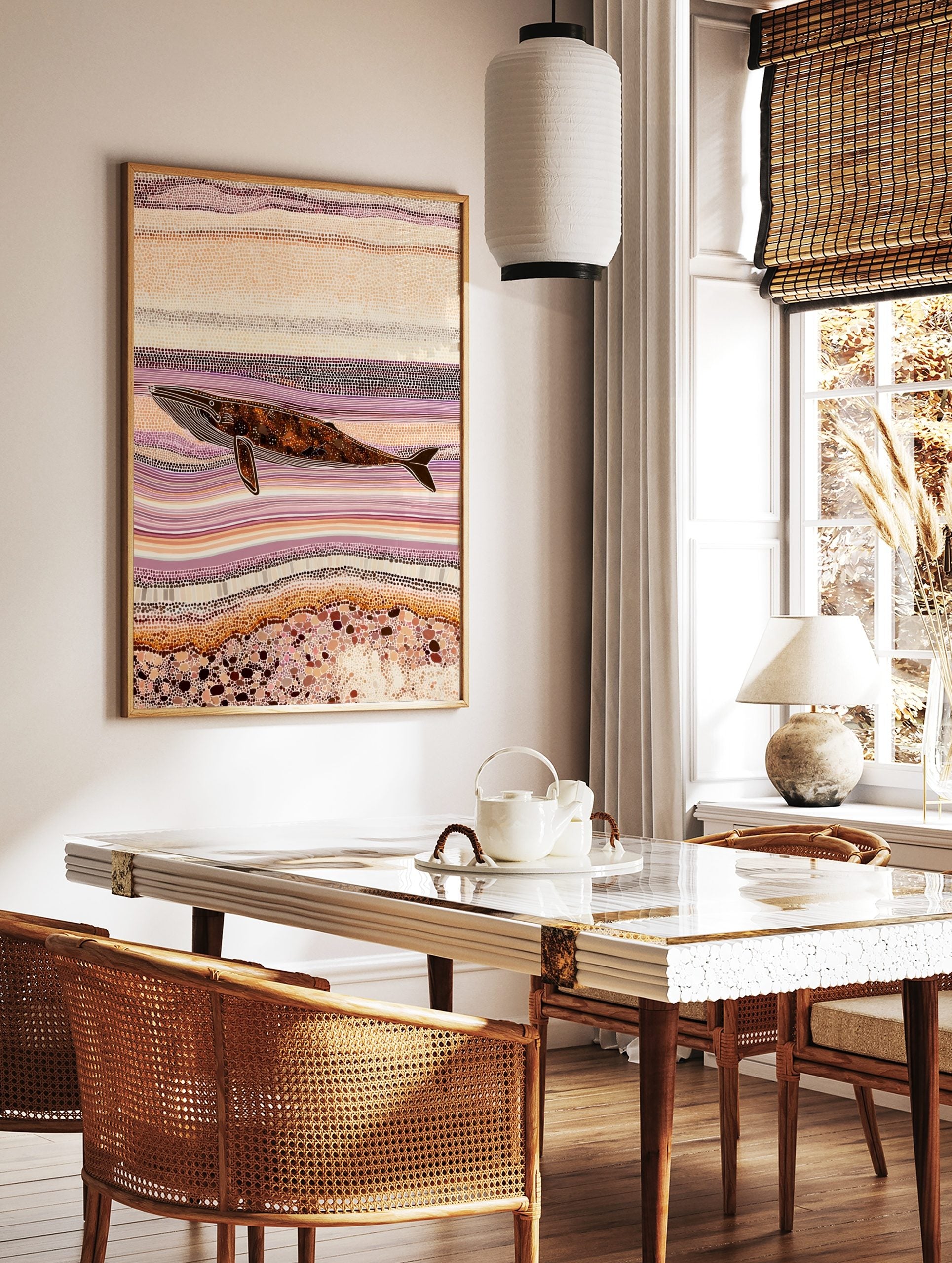 Indigenous style dot art print of a whale swimming horizontally amidst abstract purple and, in a styled room mockup