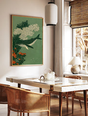 Spotted whale swimming amongst white coral and orange flowers on a green background, illustrative, in a styled room mockup