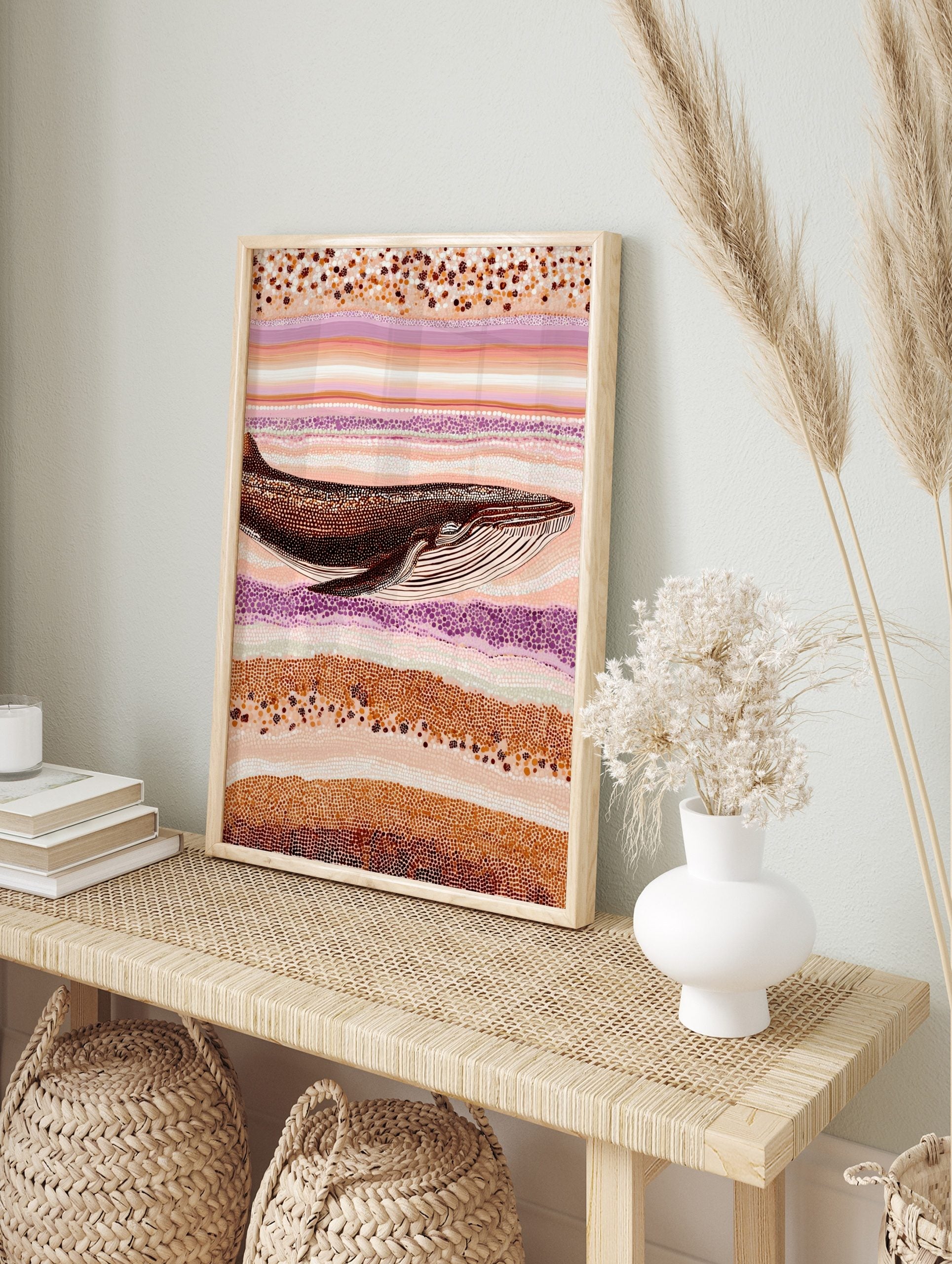 Whale art print in Aboriginal dot painting style with brown, orange, cream, and purple wavy, in an alternate framed mockup