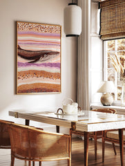 Whale art print in Aboriginal dot painting style with brown, orange, cream, and purple wavy patterns, in a styled room mockup