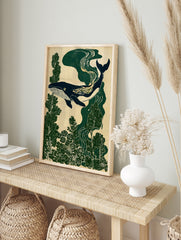 Stylised whale illustration swimming through deep green forest foliage on a neutral textured, in an alternate framed mockup