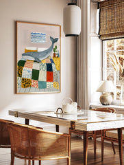 Illustrative whale wall art print showing a blue whale on a colorful patchwork quilt in a bedroom with a yellow nightstand. - Image 2