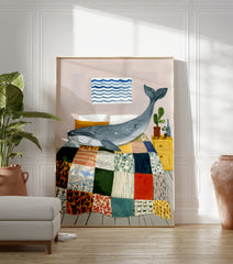 Illustrative whale wall art print showing a blue whale on a colorful patchwork quilt in a bedroom with a yellow nightstand. - Image 3