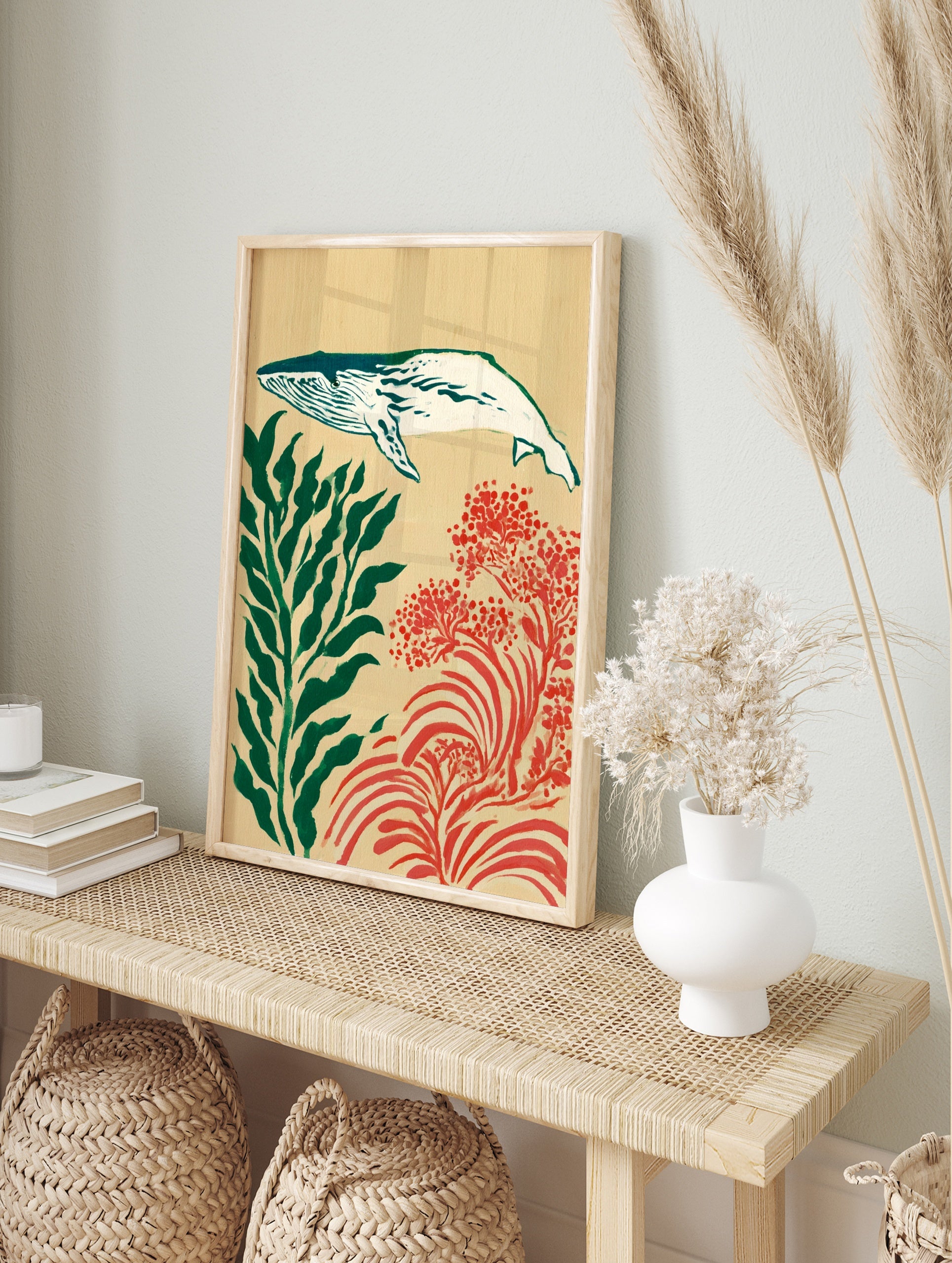 Whale illustration with green seaweed and red coral on a tan background art print, in an alternate framed mockup