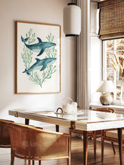 Illustrative watercolor print of two blue whales swimming among green seaweed on a white background, in a styled room mockup