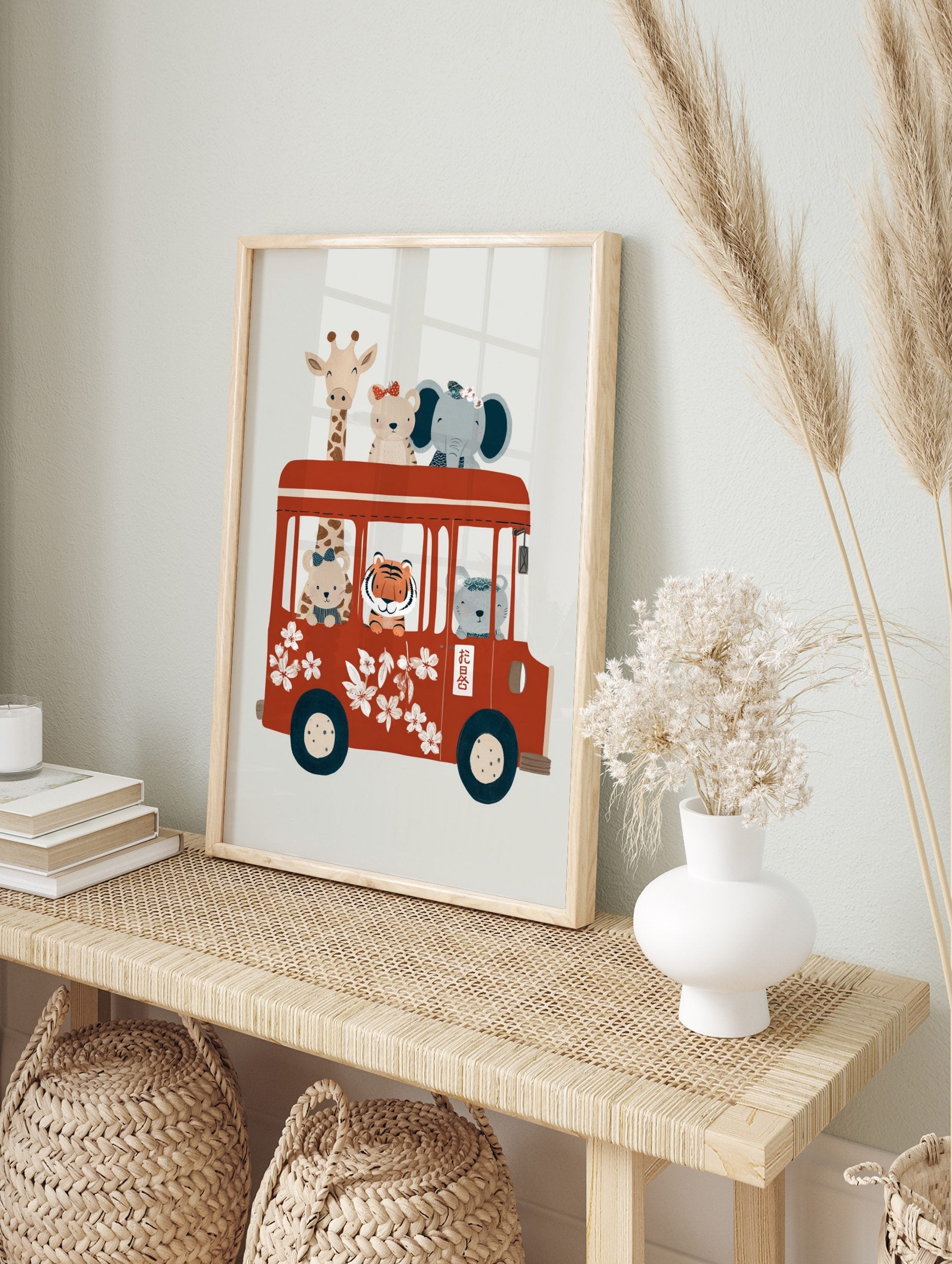 Whimsical illustration of cartoon animals (giraffe, bears, elephant, tiger) riding a red bus, in an alternate framed mockup