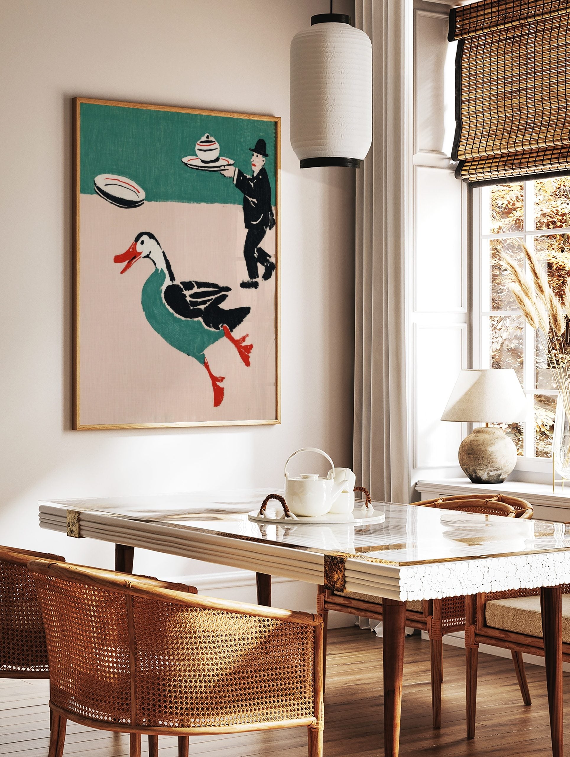 Whimsical illustrative print of a running teal duck with red beak and a waiter carrying a lidded, in a styled room mockup