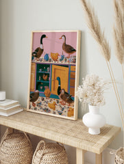 Surreal kitchen art print with mallards and yellow ducks surrounded by floral teapots and, in an alternate framed mockup