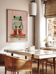 Whimsical frog wall art wearing a striped shirt and red rain boots against a pink and white striped background. - Image 2