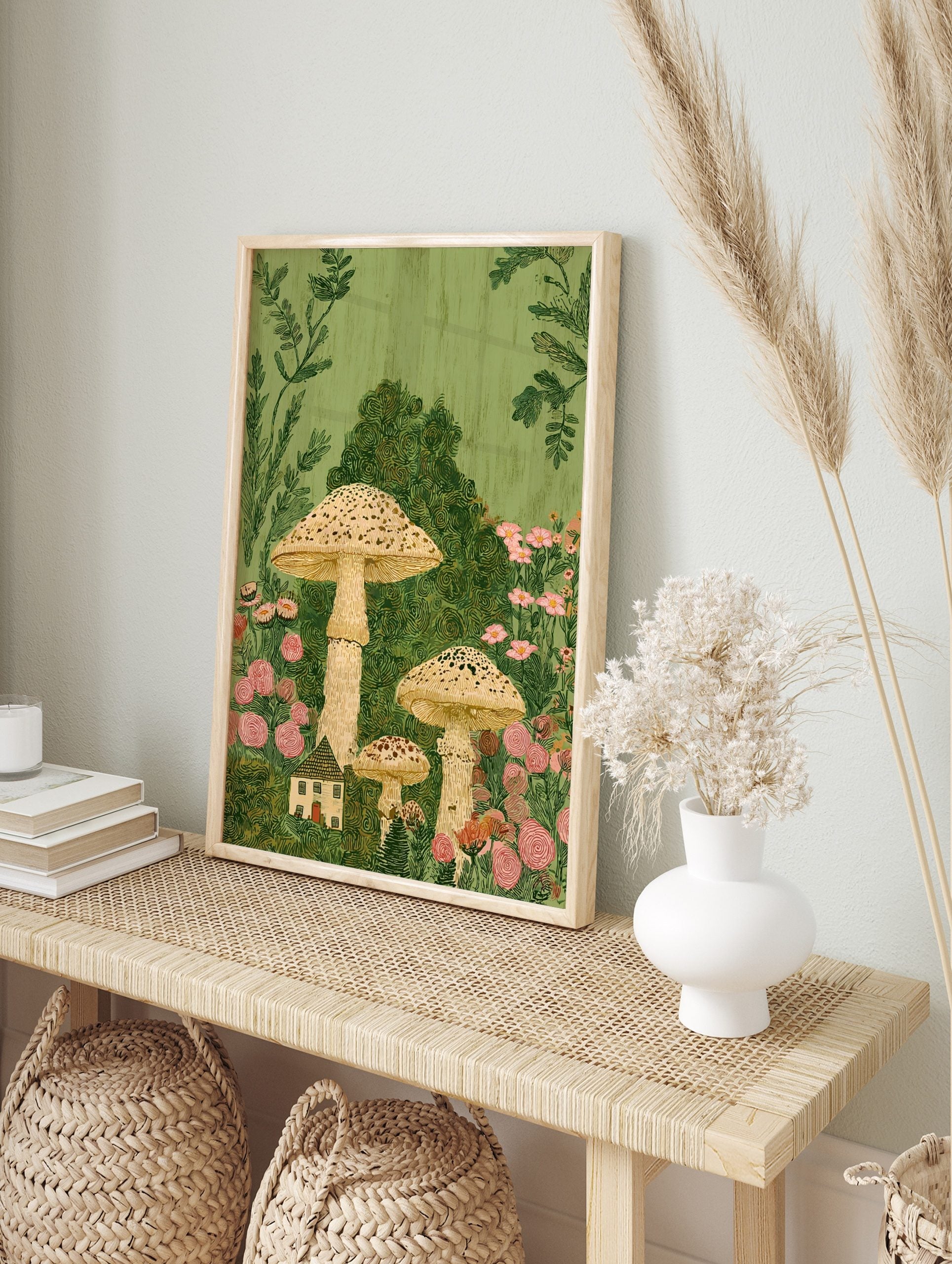Whimsical illustration of tall speckled mushrooms, a small cottage, and pink flowers in lush, in an alternate framed mockup