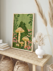 Whimsical illustration of tall speckled mushrooms, a small cottage, and pink flowers in lush, in an alternate framed mockup