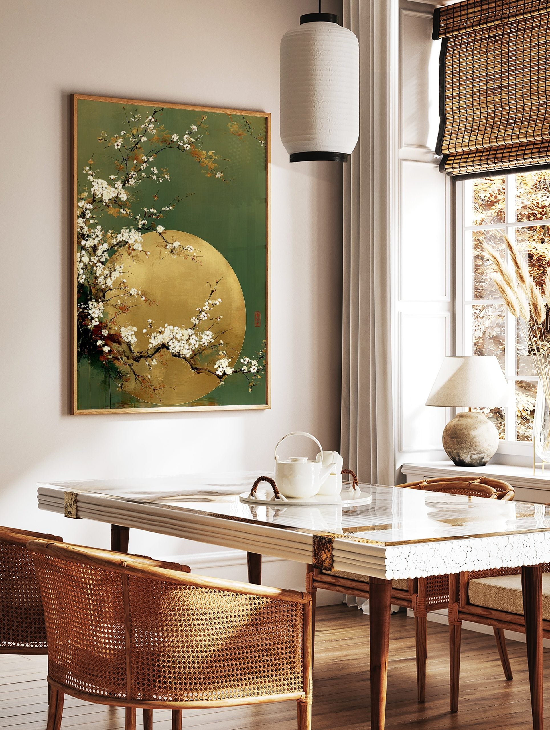 White cherry blossom branches curving over a golden full moon against a deep green background, in a styled room mockup