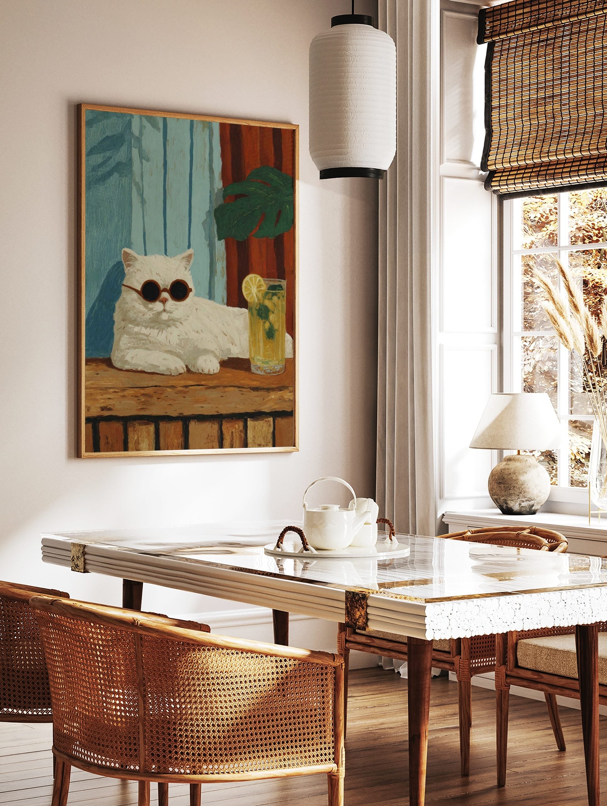 Illustrative white cat with round sunglasses, lemonade, blue and red striped background, green leaf, in a styled room mockup