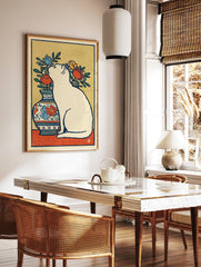White cat wall art sitting next to a vase with red, blue, and yellow flowers in an illustrated, vintage style. - Image 2