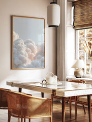 Voluminous white clouds with soft, warm glow against a light blue sky, filling the bottom of the, in a styled room mockup