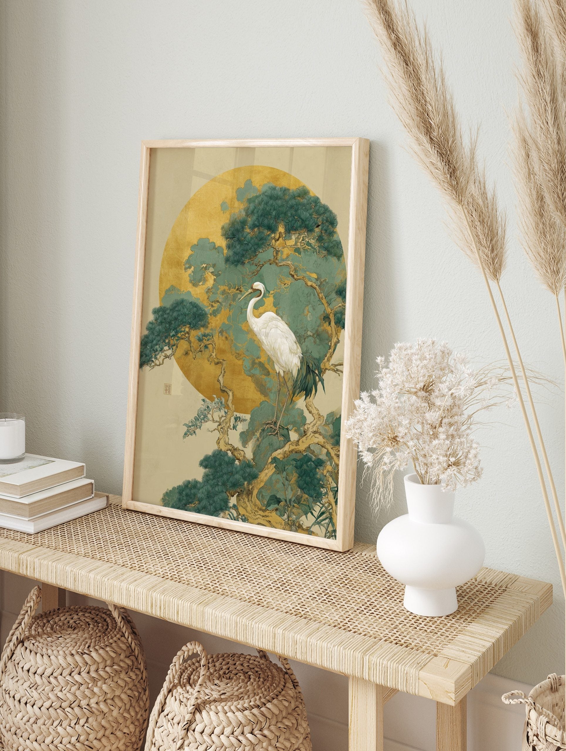 White crane standing on a pine tree branch against a large golden moon and teal-green foliage, in an alternate framed mockup