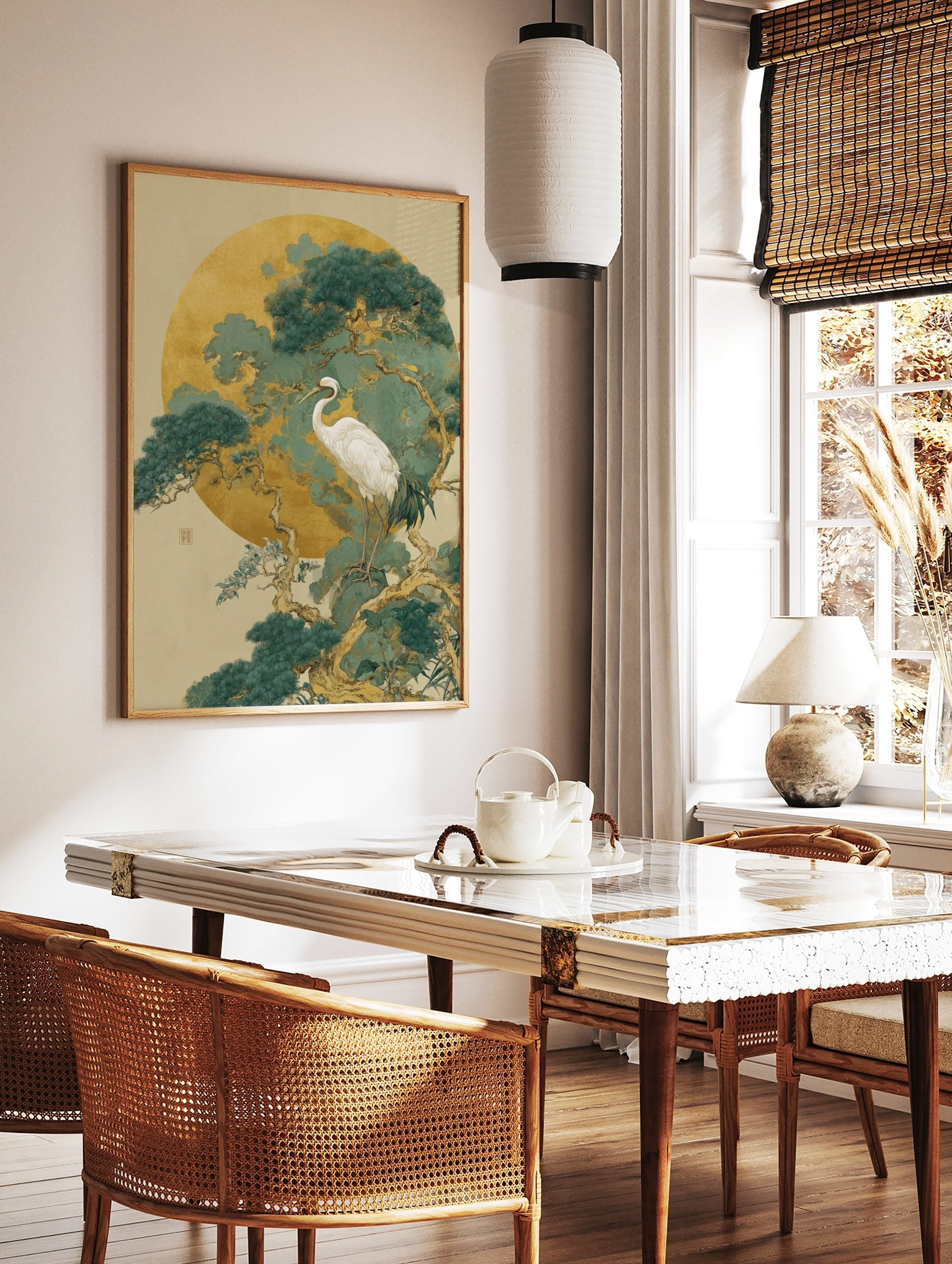 White crane standing on a pine tree branch against a large golden moon and teal-green foliage art, in a styled room mockup