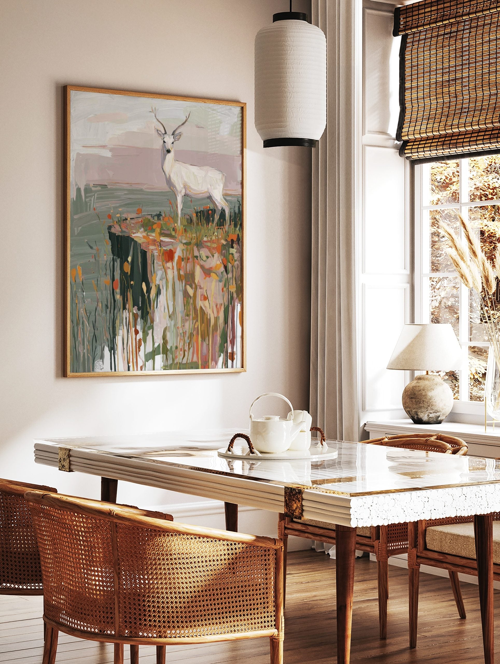 White deer with antlers standing on a cliff edge with orange and yellow grasses in a painterly style, in a styled room mockup