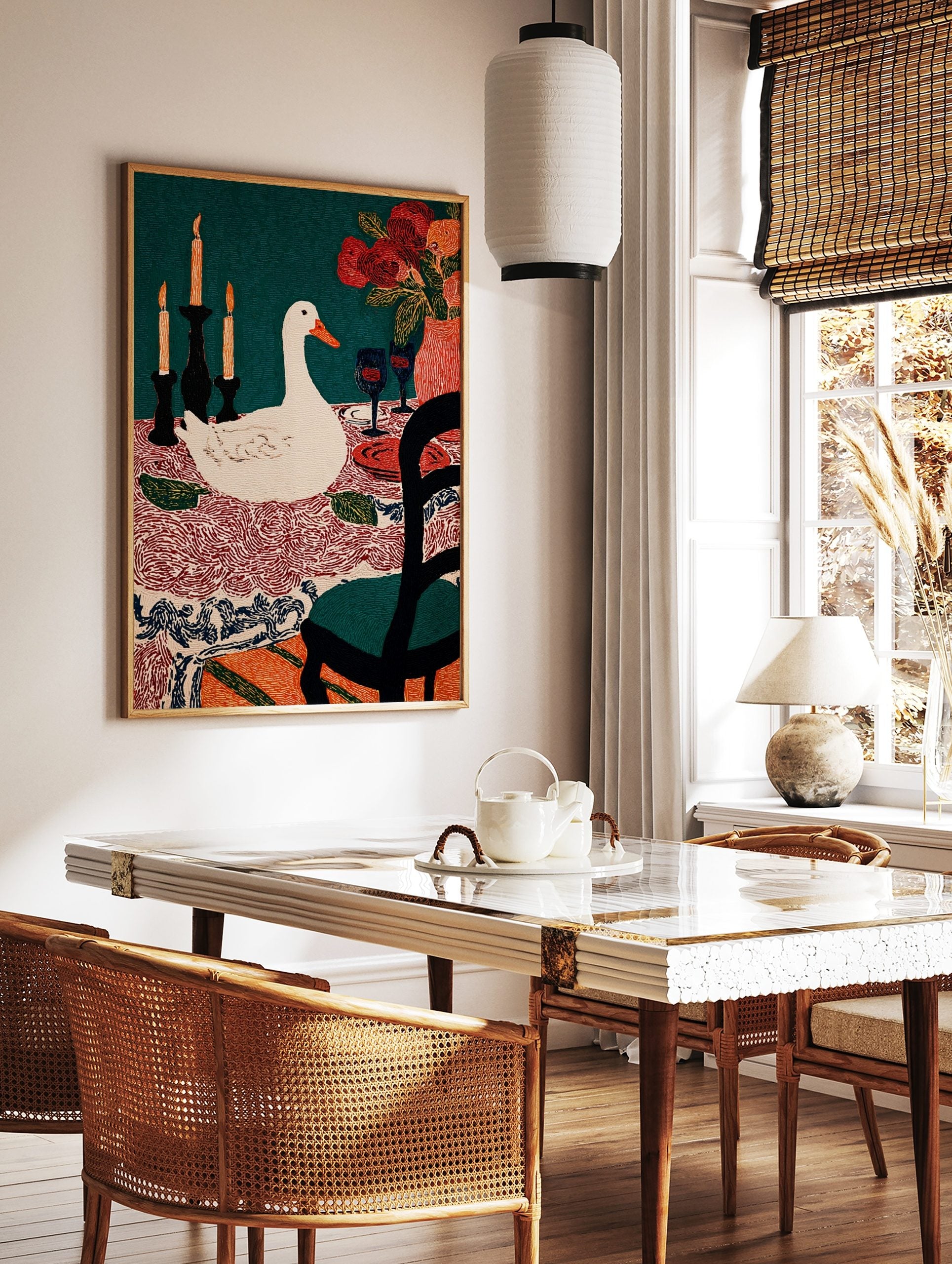 Illustrative print of a white duck at a dining table with candles, flowers, wine glasses, and a, in a styled room mockup