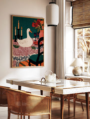 Illustrative print of a white duck at a dining table with candles, flowers, wine glasses, and a, in a styled room mockup