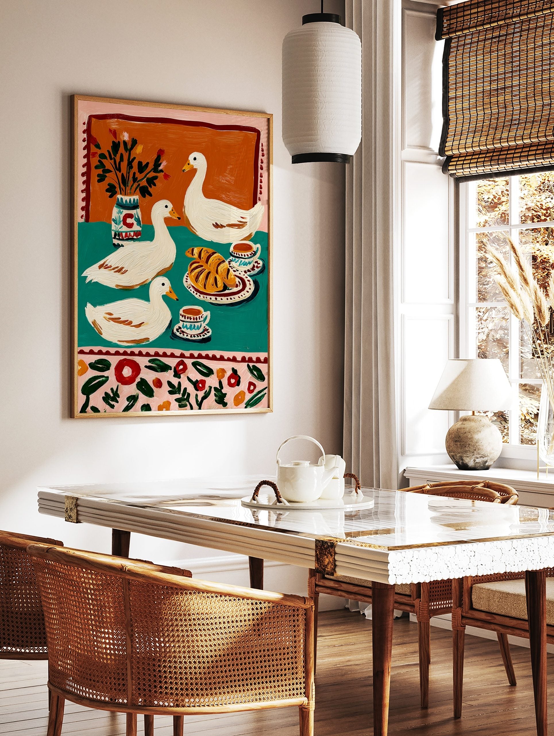 Illustrative print of three white ducks with croissants, coffee, and a vase on a teal and orange, in a styled room mockup