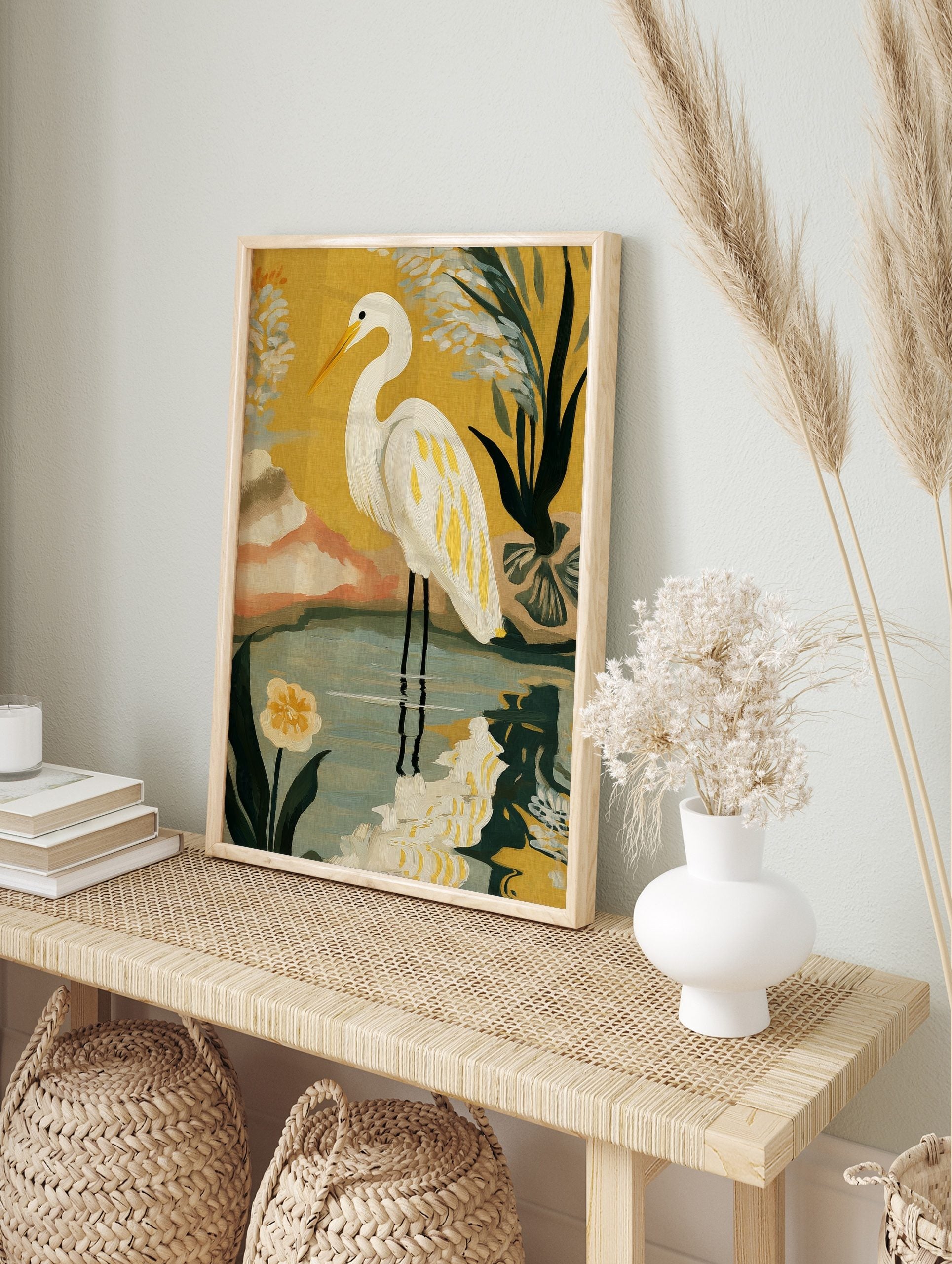 Illustrative white egret bird with yellow feathers standing in water against a yellow, in an alternate framed mockup