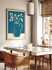 White flowers in a blue pitcher with gold outlines, a minimalist botanical illustration print on a, in a styled room mockup