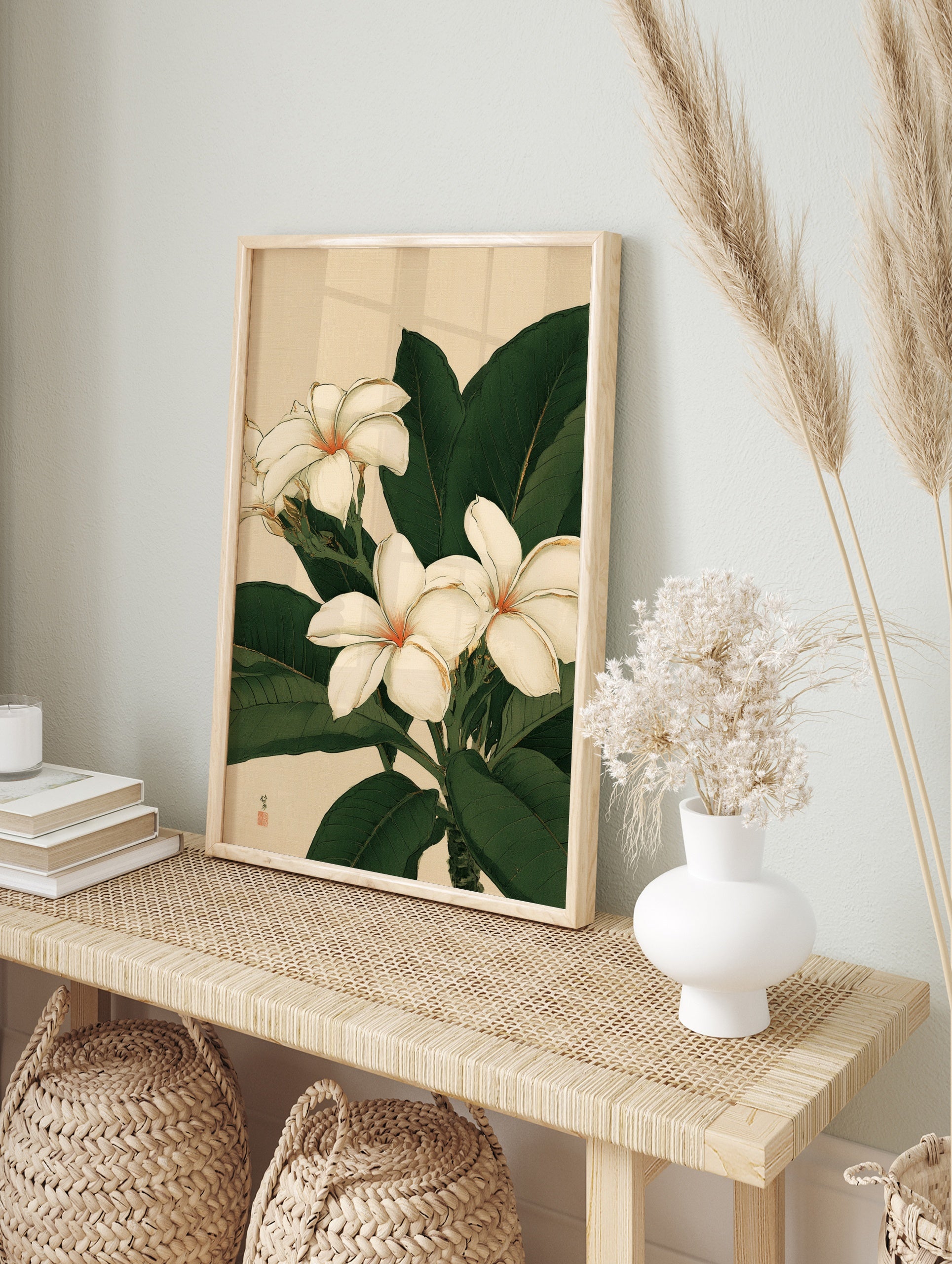 Botanical illustration of white plumeria flowers with green leaves on a neutral background, in an alternate framed mockup