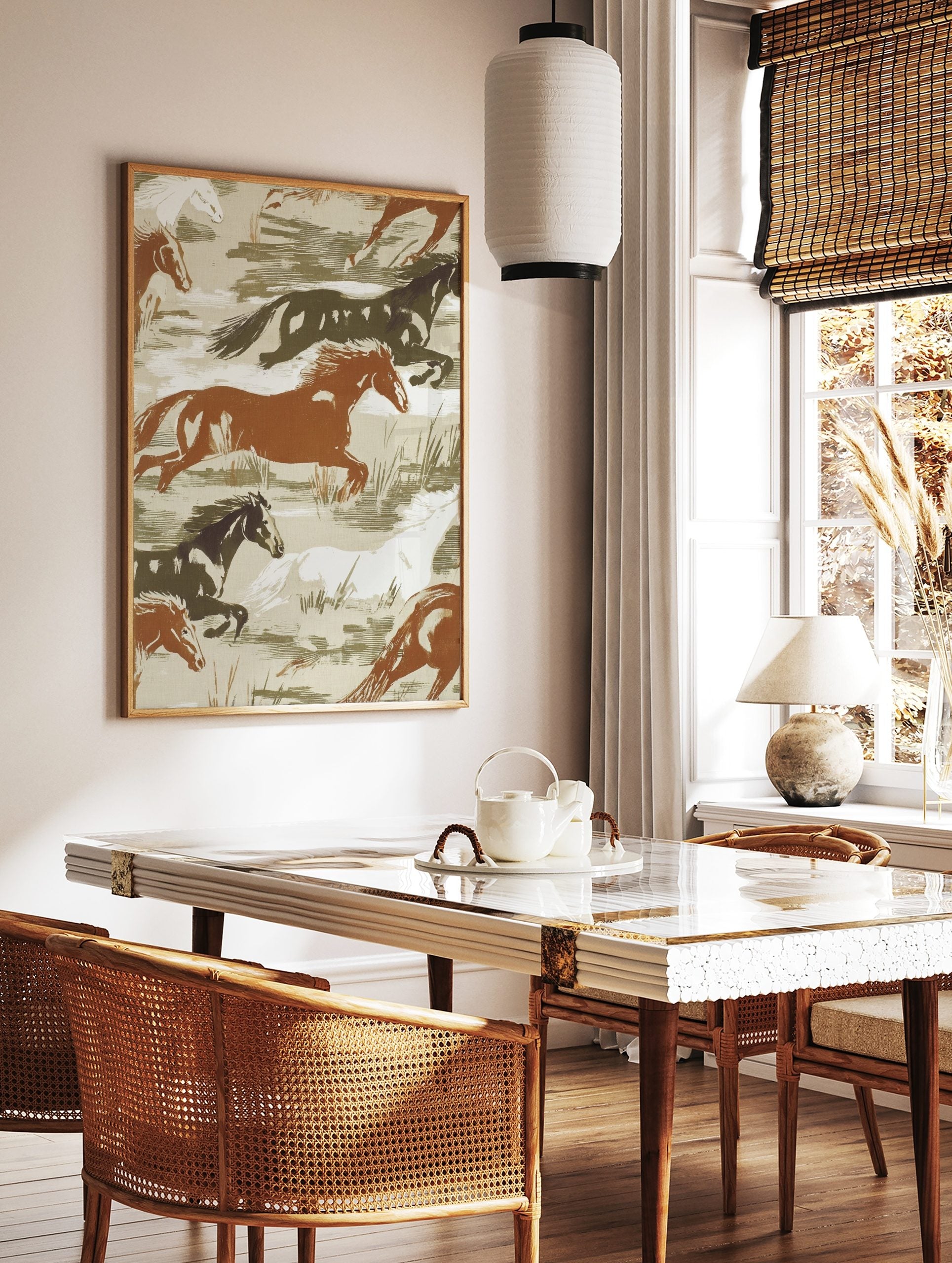 Illustrative print of wild horses galloping in brown, white, and dark green tones on a beige, in a styled room mockup