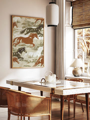 Illustrative print of wild horses galloping in brown, white, and dark green tones on a beige, in a styled room mockup