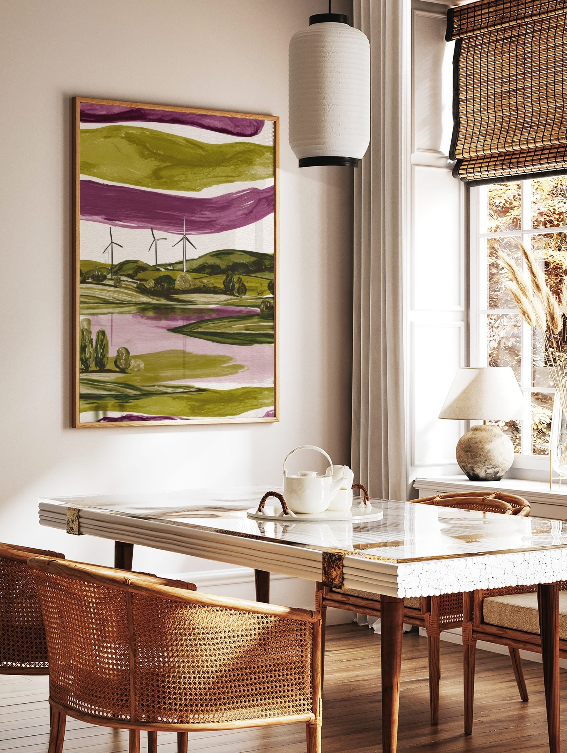 Modern abstract landscape art print with three wind turbines, green hills, and a purple lake, in a styled room mockup