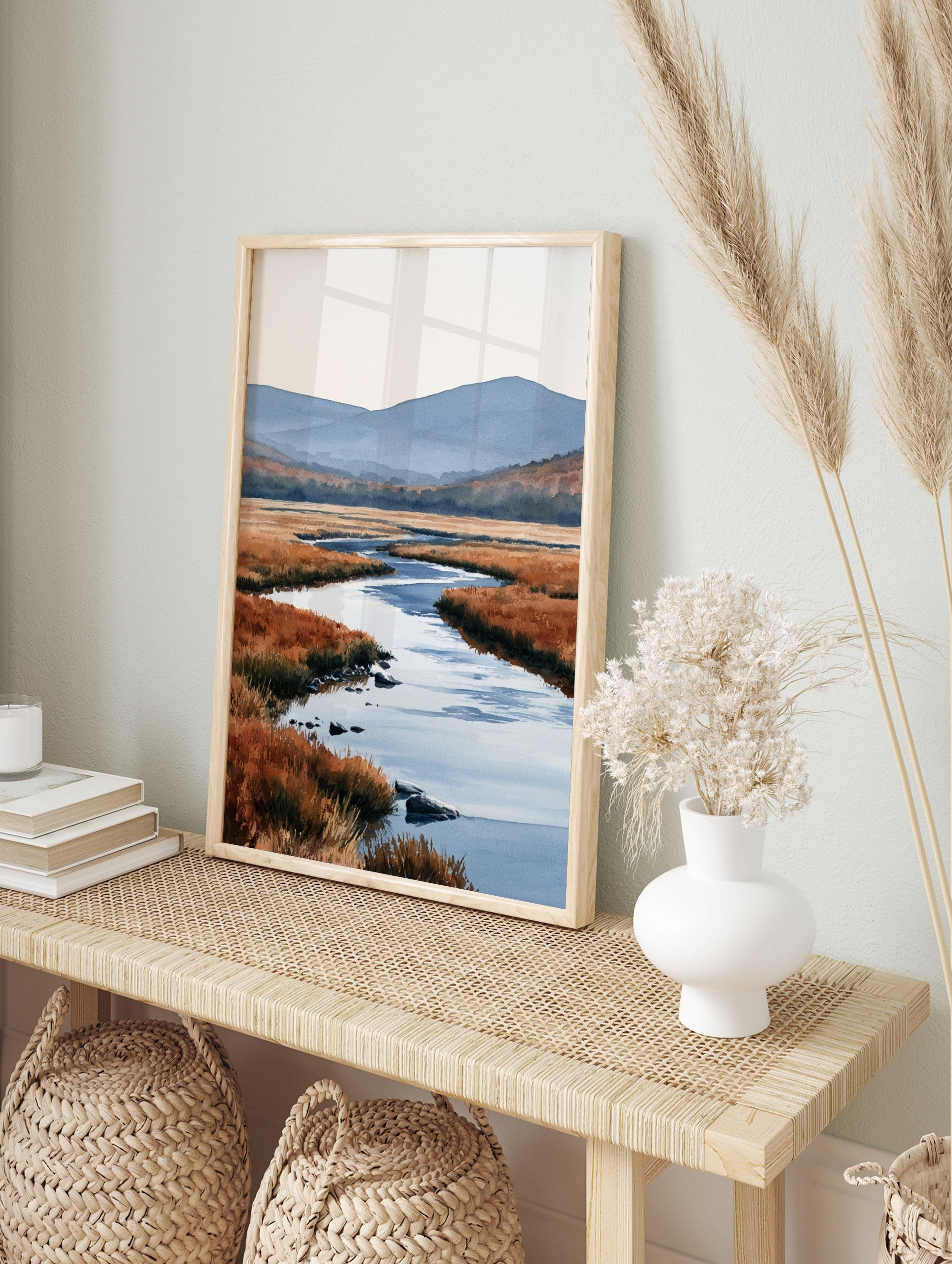 Watercolour landscape art print of a winding river through orange marshland with blue, in an alternate framed mockup