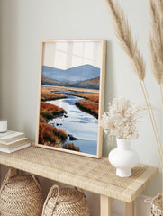Watercolour landscape art print of a winding river through orange marshland with blue, in an alternate framed mockup