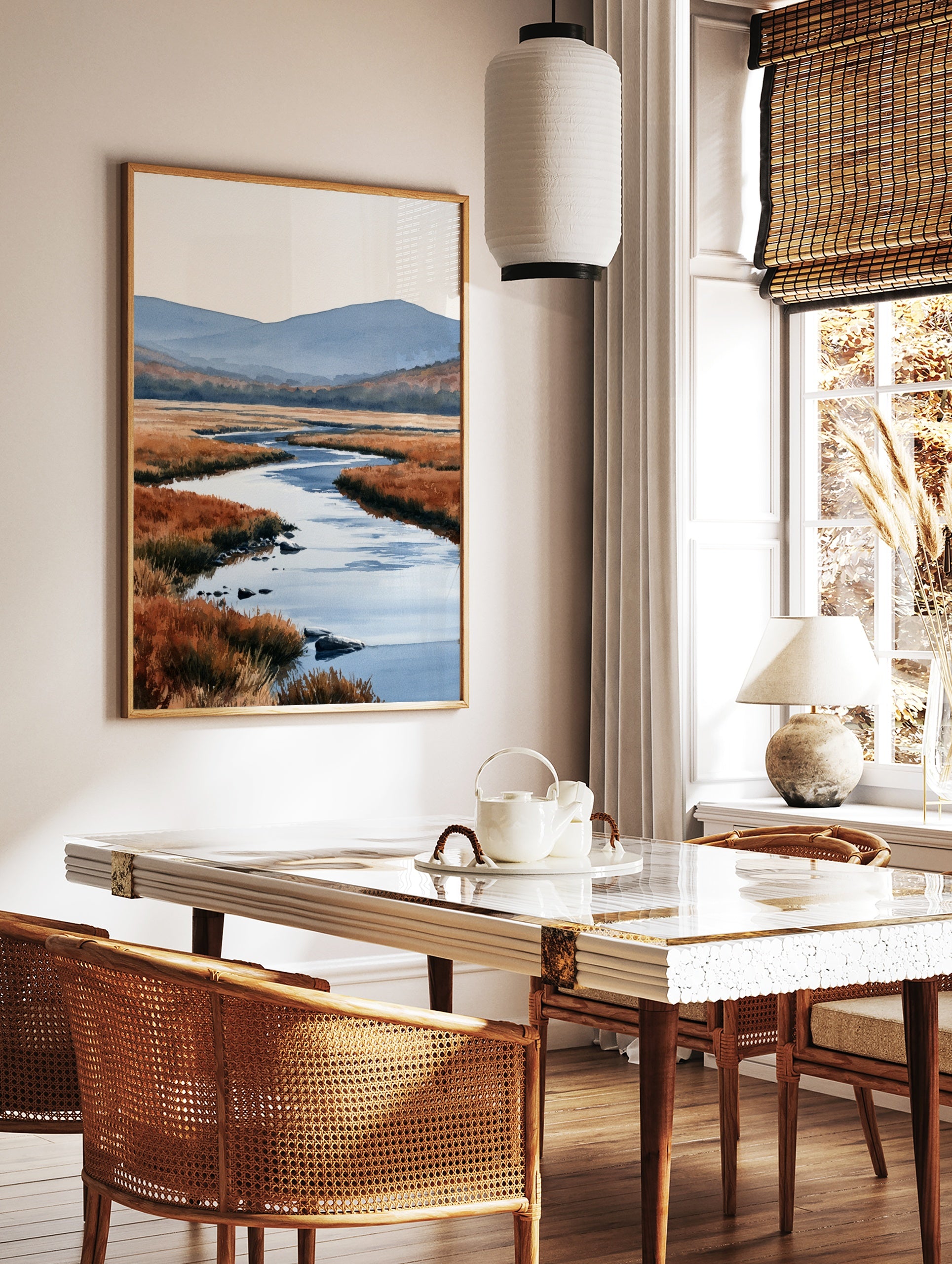 Watercolour landscape art print of a winding river through orange marshland with blue mountains in, in a styled room mockup