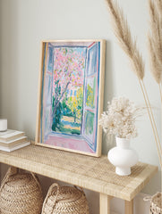 Impressionist Window View Poster showing a vibrant pink blossom tree in a lush green garden with a building in the background. - Image 4