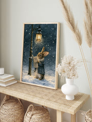 Watercolor illustration of a brown rabbit in a blue coat reading a newspaper under a lit, in an alternate framed mockup