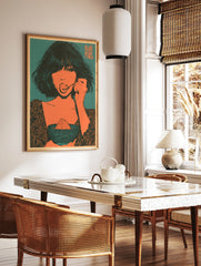 Illustrative art print of a woman eating dessert in orange and teal, featuring kanji text in the, in a styled room mockup