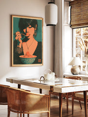 Stylized retro illustrative art print of a woman eating a strawberry from a bowl, teal background, in a styled room mockup